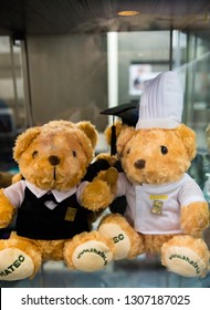 Singapore City, Singapore; January 23,2019: Two Stuffed Bears Wearing Chefs And Waiter Uniform On Display In Glass Case At SHATEC International Hotel And Tourism School. 