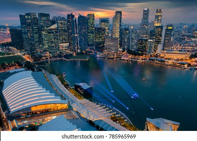 Singapore City Skyline. Business District Aerial View. Downtown Landscape Reflected In Water At Sunset In Marina Bay