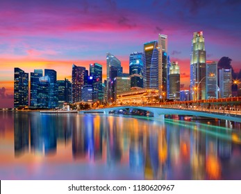 Singapore City Skyline Landscape. Business District View. Downtown Reflected In Water At Pink Sunset In Marina Bay. Travel Cityscape