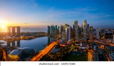 Singapore City And Sunrise Sky In Harbour Side View Of Hotel Windows