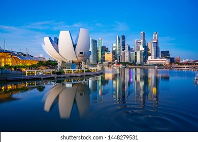 Singapore City And Sunrise Sky In Harbour Side View Of Hotel Windows