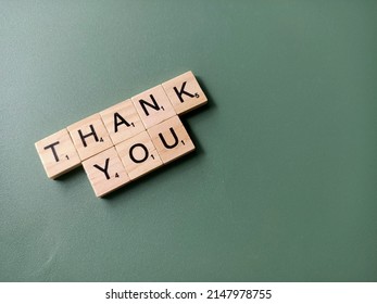 Singapore - Dec 17 2021: The Word THANK YOU Spelt Out With Wooden Scrabble Letter Tiles With Copy Space