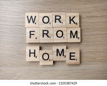 Singapore - Dec 24 2021: The Word WORK FROM HOME Spelt Out With Wooden Scrabble Letter Tiles