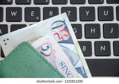 Singapore Dollars Banknotes on a black keyboard - Shutterstock ID 1225811200