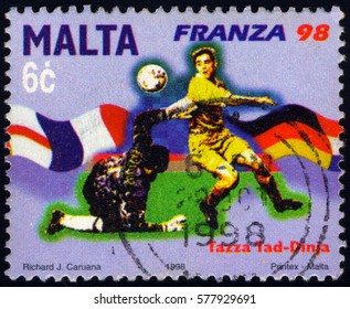 SINGAPORE – FEBRUARY 13, 2017: A Stamp Printed In Malta Shows FIFA World Cup 1998 - France, Circa 2002
