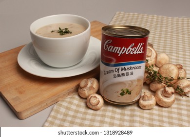 SINGAPORE, SINGAPORE - February 20, 2019: The Campbell Soup Company Cream Of Mushroom Soup Can Product Photography Soup With Fresh Mushrooms. Andy Warhol Used Campbell's Soup Cans In Pop Art.