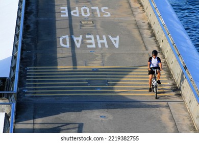 Singapore - February 22, 2021: Man Riding Bicycle On Street Or Road At Marina Bay, Singapore. Activity And Exercise.