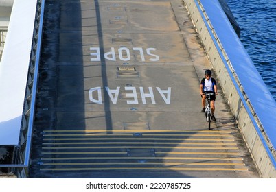 Singapore - February 22, 2021: Man Riding Bicycle On Street Or Road At Marina Bay, Singapore. Activity And Exercise.