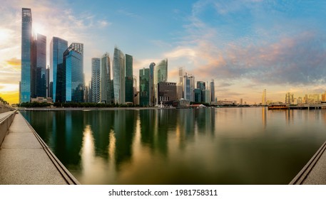 Singapore Financial District Skyline At Marina Bay On Sun Set Time, Singapore City, South East Asia.