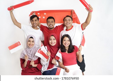 Singapore Flag Day. Young Joyful Group Of People Holds Flag Of Singapore Celebrate Together Of Independence Day