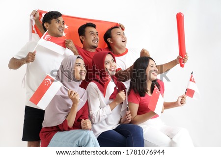 Singapore Flag Day. Young joyful group of people holds Flag of Singapore Celebrate together of Independence day