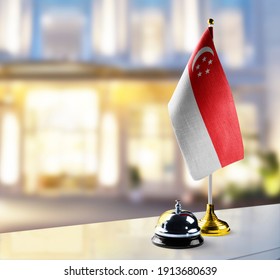 Singapore Flag On The Reception Desk In The Lobby Of The Hotel