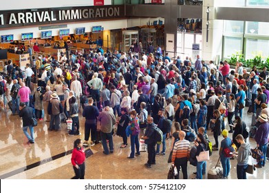 SINGAPORE - JAN 13, 2017: People waiting in queue at arrival immigration of Changi airport. Changi International Airport serves more than 100 airlines operating 6,100 weekly flights.