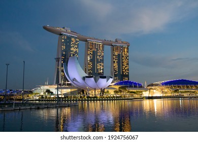 Singapore - Jan 22, 2021: Artscience Museum and Marina Bay Sands tower in the evening time. ArtScience Museum is a museum within the integrated resort of Marina Bay Sands in the Downtown central area