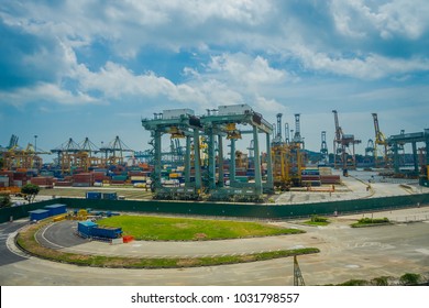 SINGAPORE, SINGAPORE - JANUARY 30, 2018: Outdoor view of some metallic structures at the Port of Singapore. Ship-to-shore STS gantry cranes at shipping yard. Sentosa Island