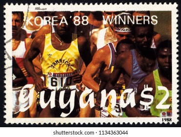 SINGAPORE - JULY 15, 2018: A Stamp Printed In Guyana Shows Running, 1988 Summer Olympics, Korea, Circa 1988