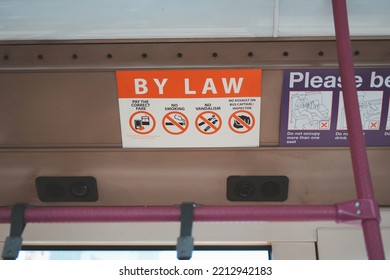 SINGAPORE - JULY 27, 2022 : Signs By Law On Bus Singapore. Public Transport In The City Singapore.