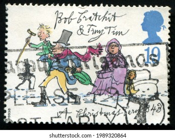 SINGAPORE – JUNE 11, 2021: A Stamp Printed In United Kingdom Shows Image Of The Bob Cratchit And Tiny Tim , Circa 1993.