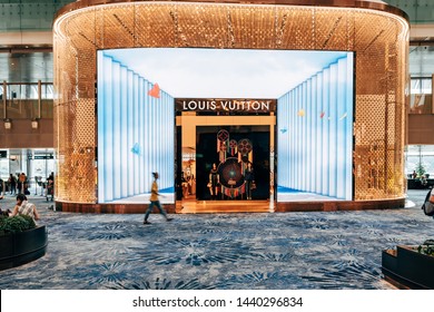 Singapore - June 19, 2019: Louis Vuitton Shopping in Changi Airport in Singapore. Futuristic Display, Entrance and People.