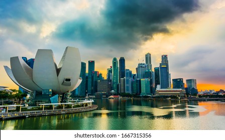 SINGAPORE - MAR 6, 2020: Singapore downtown waterfront with ArtScience Museum seen from Helix Bridge after sunset