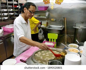 Singapore, March 8, 2016: A Man Cooks In The Restaurant Of A Typical Singapore Food Court Or Hawker