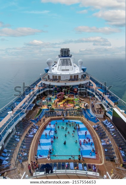 Singapore, Singapore - May 14, 2022: Aerial view of\
the upper deck of the Ovation of the Sea cruise ship with many\
leisure and entertainment areas on board. Royal Caribbean cruise\
ship at sea