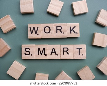 Singapore - May 8 2022: The Word WORK SMART Spelt Out With Wooden Scrabble Letter Tiles