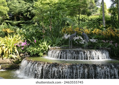 Singapore - a nice fountain with bronze flamingos accompanied by orchids in national orchid garden - Powered by Shutterstock