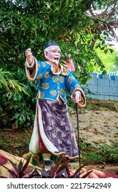 Singapore - Oct 18, 2022 : Traditional Chinese Man Leading The Way At Haw Par Villa Theme Park. This Park Has Statues And Dioramas Scenes From Chinese Mythology, Folklore, Legends, And History.