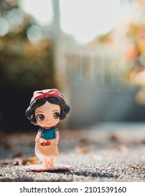 SINGAPORE, SINGAPORE - Oct 23, 2021: A Vertical Shot Of A Plastic Snow White Toy Outdoors On The Ground