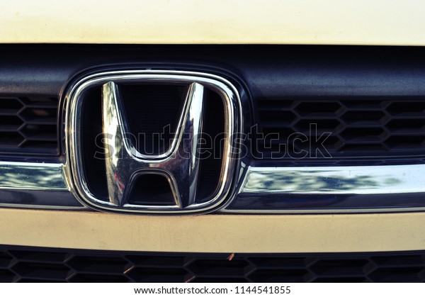 SINGAPORE - OCTOBER 14, 2017: Honda car logo on a\
white Honda car. Honda Motor Corporation is a Japanese\
multinational automotive manufacturing company at Minato, Tokyo in\
Japan.