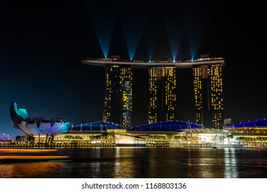 Singapore, SINGAPORE, OCTOBER 2017. Marina Bay Sands and ArtScience Museum buldings at night during the light show.