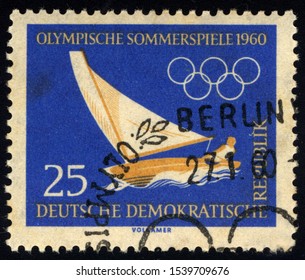 SINGAPORE - OCTOBER 24, 2019: A Stamp Printed In Germany Shows Sailing, Summer And Winter Olympics 1960, Serie, Circa 1960