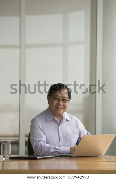 Singapore Senior Businessman Using Laptop Desk Stock Photo Edit