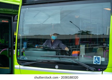 SINGAPORE, SINGAPORE - Sep 02, 2021: Bus Driver Leaving Ang Mo Kio Bus Interchange, Singapore  Close Up Shot