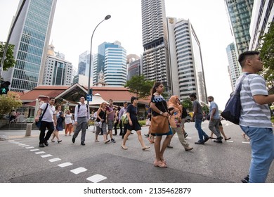 Singapore, Singapore - September 08, 2019: At The End Of The Working Day
Office Workers Walking On The Streets Of The Central Business District.