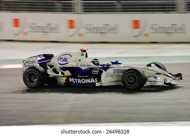 SINGAPORE - SEPTEMBER 26: Nick Heidfeld Speeding Past In His BMW Sauber During First Formula One Night Race September 26, 2008 In Singapore