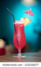 Singapore Sling Cocktail On Wooden Table In Front Of The Night Club Bokeh Lights