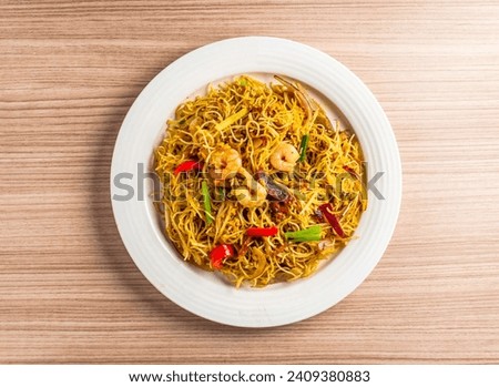singapore style fried rice noodles served in dish isolated on table top view of hong kong food