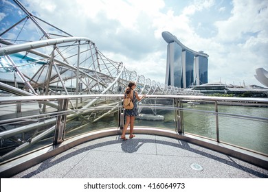 Singapore Travel Tourist Woman On Vacation  Near Marina Bay Hotel. Person In Dress  Over Singapore City Background . Asian Summer Destination