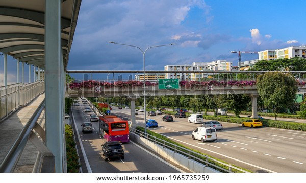 SINGAPORE-1 MAY 2021: The CENTRAL EXPRESSWAY to and from\
North to downtown. A wheelchair friendly overhead bridge with\
bougainvillaes provides access to locals to and from Toa Payoh and\
Potong Pasir. 