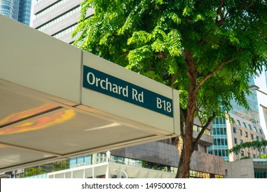 Singapore,September 2019; signs of Orchard Road around with building ,shopping mall ,many tree and car on the road. Orchard road is the famous place in singapore city for shopping and sightseeing.  
