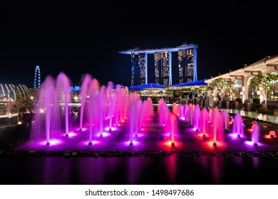 Singapore,Singapore - 2017 Sep 21 : Illuminated Singapore marina bay sand with fountain show at night around building business area in Singapore. - Shutterstock ID 1498497686