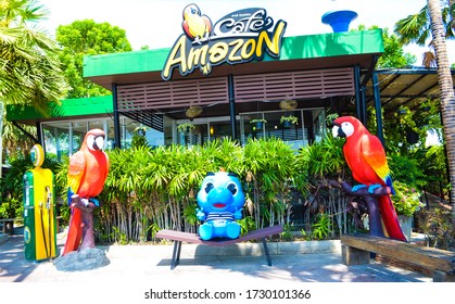 Singburi, Thailand - May 11, 2020 : Cafe Amazon coffee shop with macaw parrot statue and Godji PTT gas station mascot. Cafe Amazon is a famous Thai franchise coffee house in Thailand.