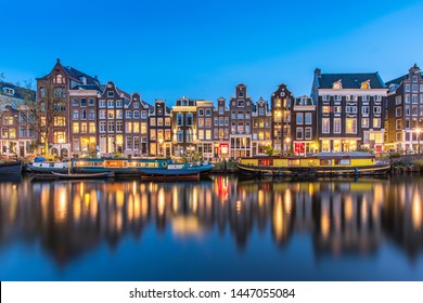 The Singel is a canal in Amsterdam which encircled the city in the Middle Ages. This famous part of the canal has spectacular houses and houseboats. - Powered by Shutterstock