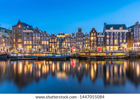 The Singel is a canal in Amsterdam which encircled the city in the Middle Ages. This famous part of the canal has spectacular houses and houseboats.