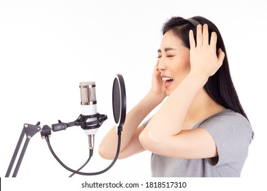 Singer Female Performing And Singing In Music Studio. Singer Asian Woman Recording Song In Recording Studio. Superstar Is Recording Famous Album. Expression Face. Isolated On White Background