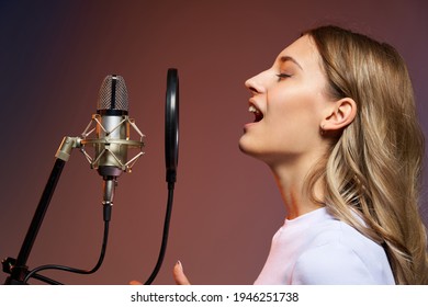 Singer Girl With Microphone. Closeup Profile Portrait Of Young Caucasian Girl Singing Enjoying With Closed Eyes