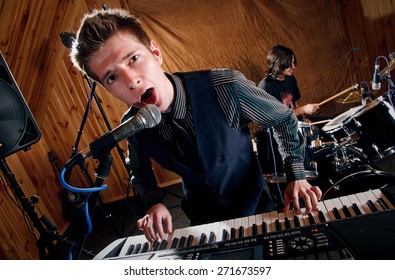 Singer Keyboard Player Sings Into A Microphone