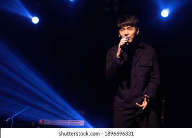 singer man posing and singing on stage